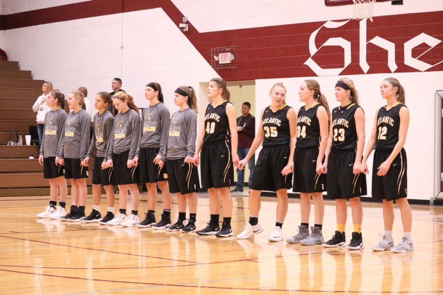 The Trojan girls stand together in Shenandoah before the game begins. The Trojan girls finished the season with a record of 4-18.