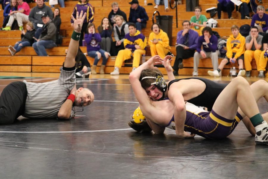 FIGHT UNTIL THE WHISTLE - Sophomore Joe Weaver competes in a tough match at the OA-BCIG tournament earlier in the season. Weaver, wrestling at 120, is one of the six Trojans advancing to districts.