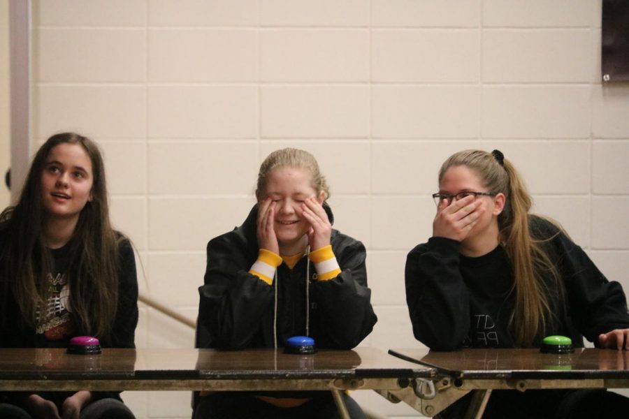 TOUGH QUESTION - Sophomore Molly McFadden (center) reacts to a question during the Jeopardy game of the opening session. Volunteers from grades 8-12 participated in this activity before dispersing to classrooms for career day.