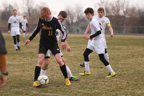 BACK OFF - Junior Ben Andersen shields the ball from a Tri-Center competitor. Andersen has been a key player for the Trojans throughout the season. 