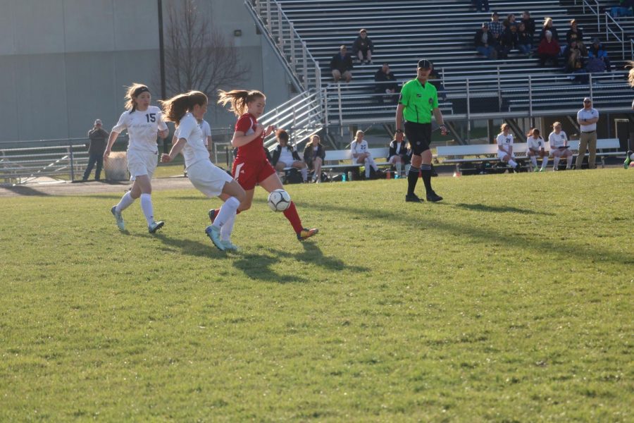 GOING FOR THE SAVE -- Sophomore Lauren Nicholas runs after the ball in the game against Harlan last year. Nicholas did not return this year. 
