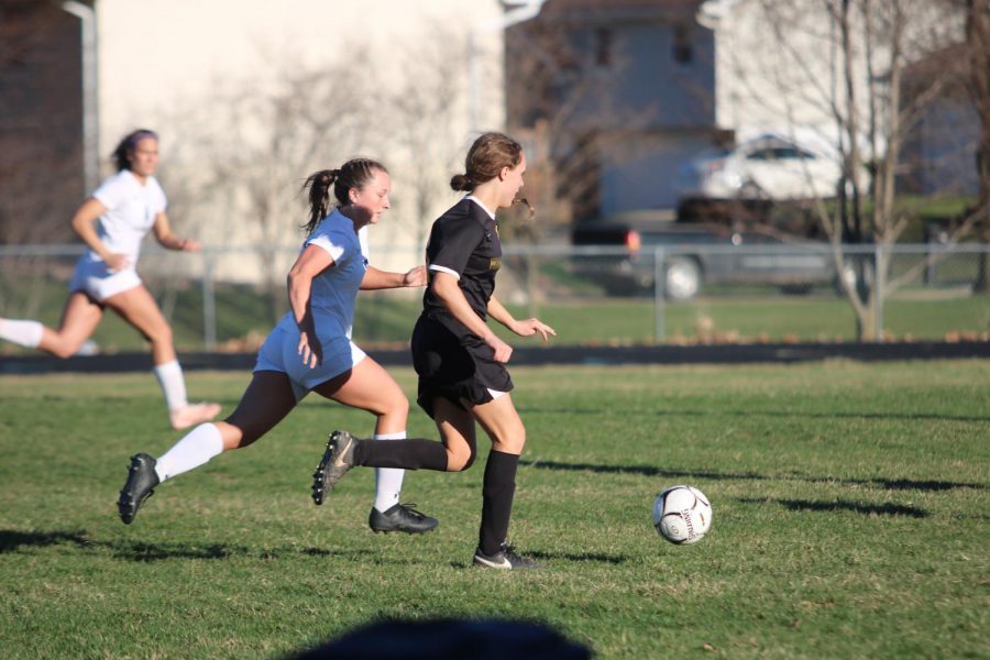 WIN THE BALL - Junior McKenzie Waters rushes after the ball to get it up the field. Waters has been involved in soccer all three years of high school.