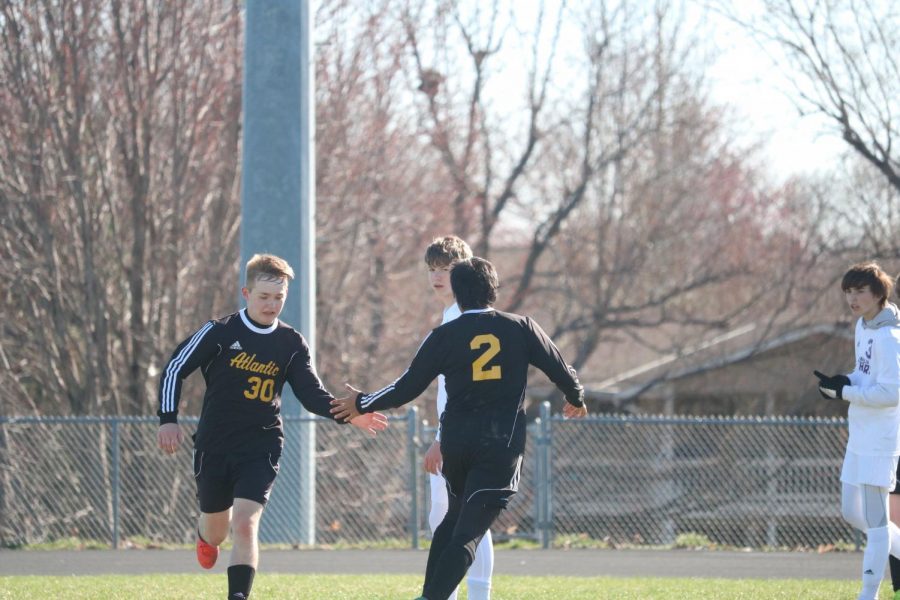 TAKING A BREAK - Senior Brainhart Buliche subs in for junior Zach Mathisen and gives him the typical high-five seen during this process. This is Mathisen's first year of playing soccer in high school.