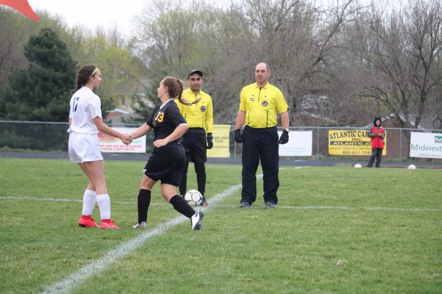 Sophomore Tatum Grubbs shakes hands with a member of the other team. 