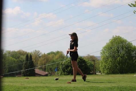 Senior Baylee Newell watches her drive from the tee off spot. Newell was a medalist at Denison-Schleswig with a score of 43. 
