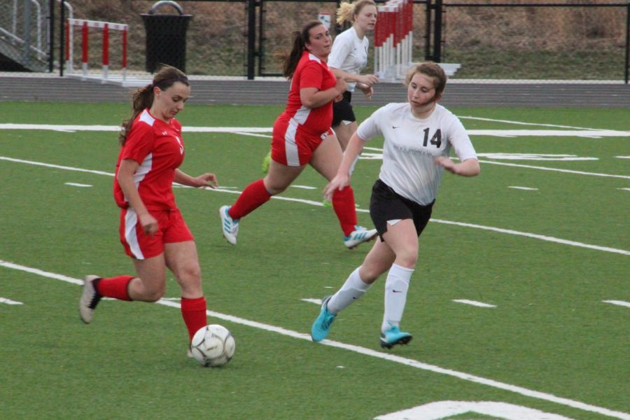 Junior Katie Saluk defends the goal against a Missouri Valley Lady Red. Saluk has been involved in soccer for three years.