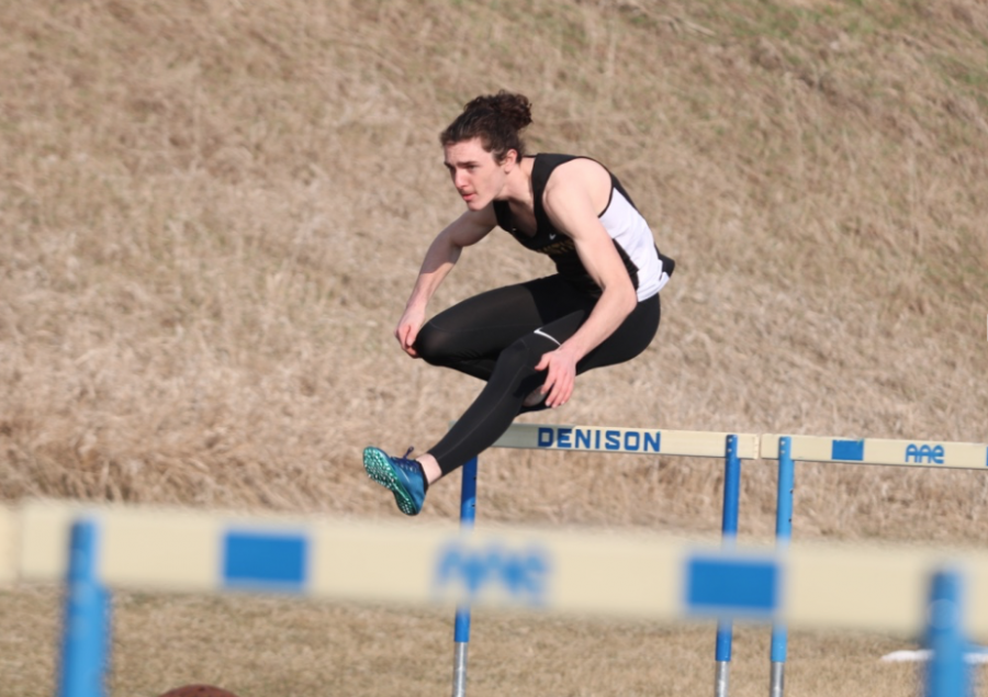 UP AND OVER - Sophomore Colin Mullinex sprints his leg of the shuttle hurdle relay event. Mullinex was joined by senior Connor Pellet, sophomore Joe Weaver and freshman Kadin Stutzman.