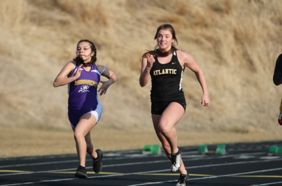NECK AND NECK - Junior Aleigh Bean inches ahead of her opponent as she flies to the finish. Bean has been involved with Track & Field since her freshman year.