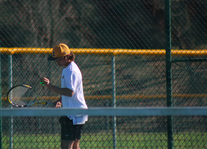 Sophomore Bodie Johnson zones in before serving at the Sunnyside courts. Johnson has played tennis both years of high school.