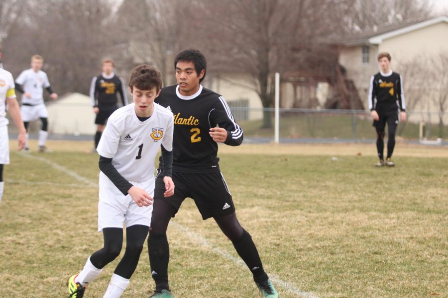 SIDESTEPPIN - Senior Brainhart Buliche lunges behind an opponent during the Tri-Center game. Buliche plays defense for the Trojans.