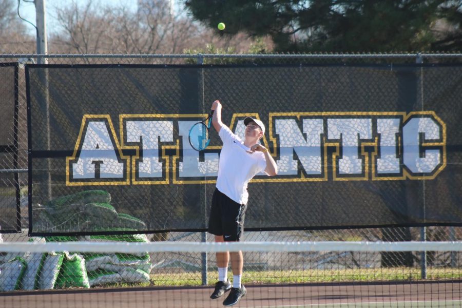 Junior+Nile+Petersen+serves+the+ball+to+his+opponent.+Petersen+qualified+for+state+for+the+second+year+in+a+row+following+a+successful+day+at+districts.+