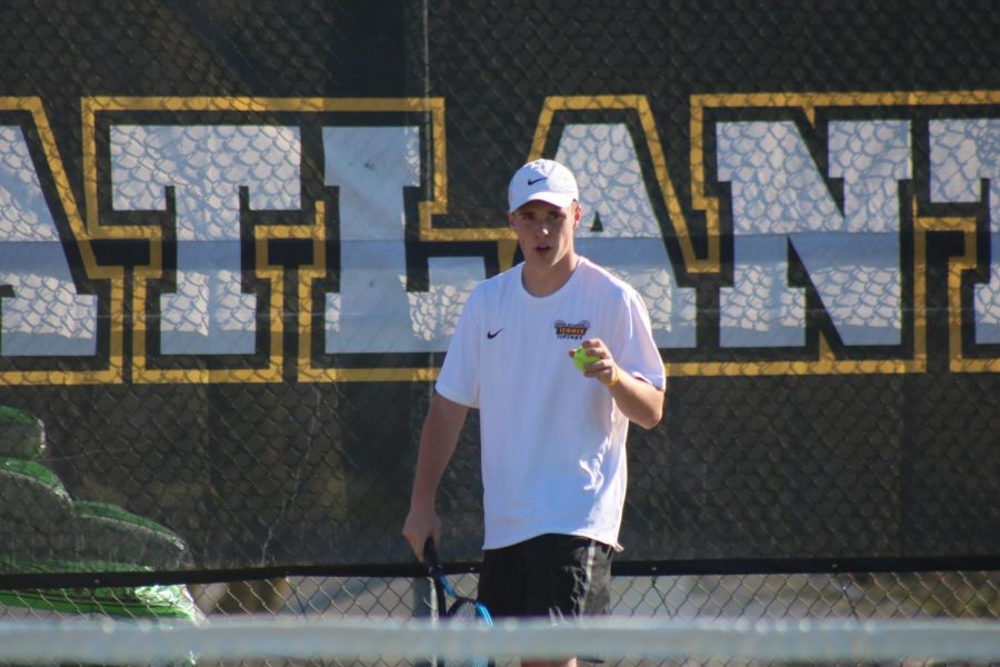 Junior Nile Petersen prepares to serve on court #1 at Washington Elementary. Petersen went 1-2 in his second state berth.