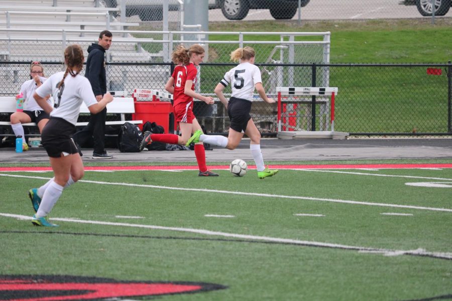 Seniors+Erin+Wendt+and+Sadie+Welter+defend+the+goal+while+junior+Emma+Templeton+is+patiently+waiting+to+be+subbed+in.