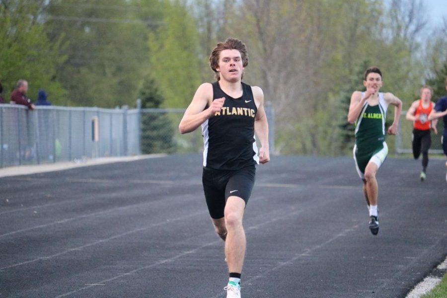 DOWN THE HOME STRETCH - Senior Chase Mullenix strides down the straightaway at the co-ed home track meet. Mullenix qualified in several events for the state meet. 
