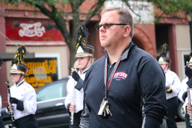 High school band director Jarrod O’Donnell walks with the Trojan Guard at the 2018 Homecoming Parade. Aside from the halftime performances, the band will play in two parades--the Clarinda Band Jamboree and the Homecoming parade. 