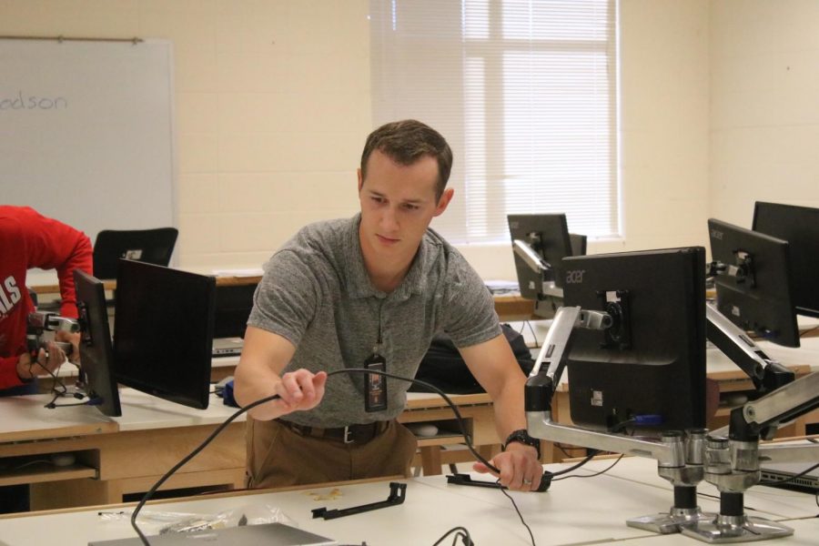 Dexter Dodson fixes a cable during class in the first few days of school. This is his sixth year teaching. 