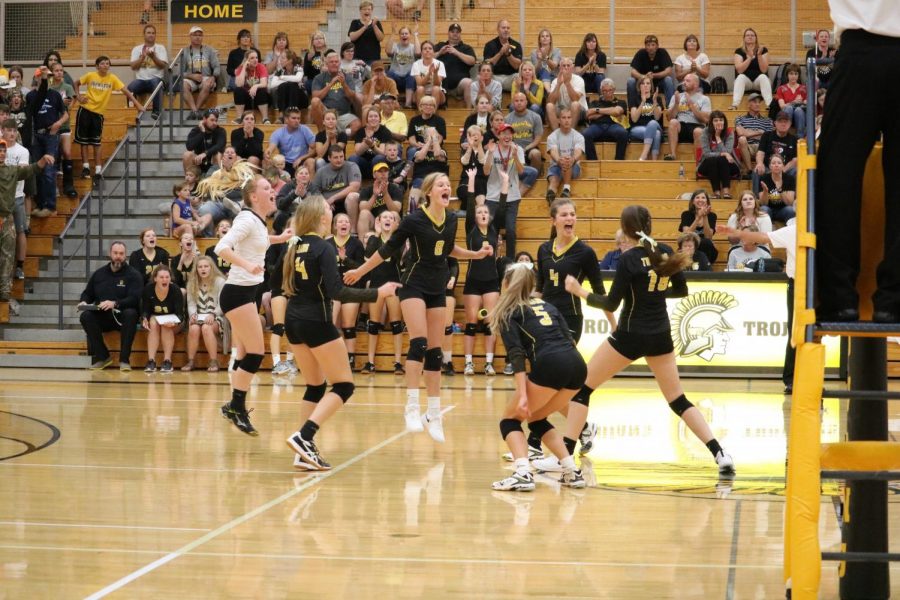 The Trojan volleyball team celebrates on Thursday against the Cyclones. So far this season, Atlantic has won 17 total sets. 