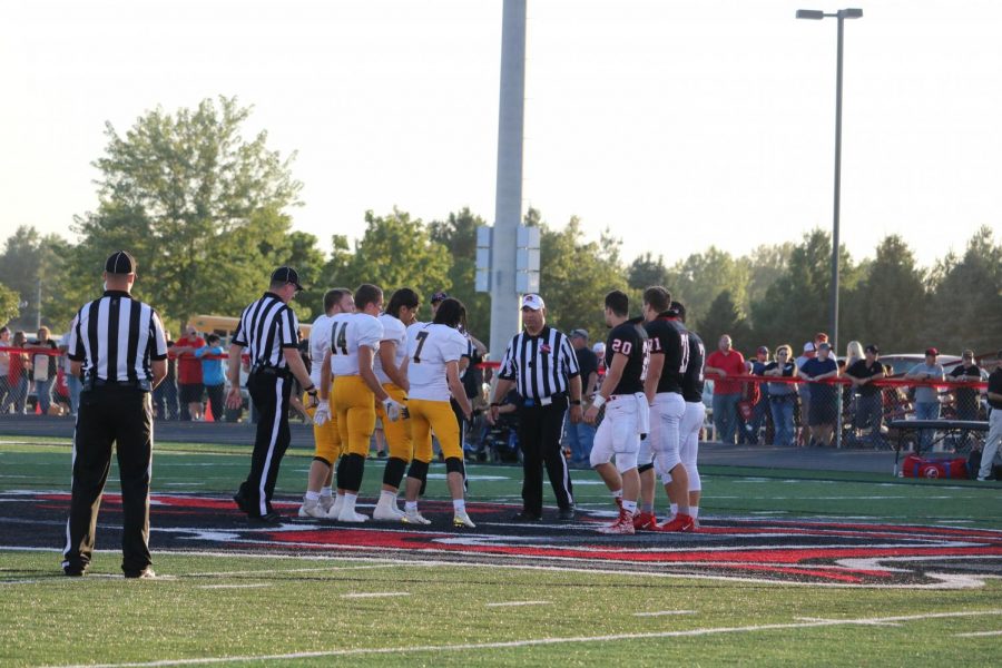 The 2019 football captains head to midfield for the coin toss against Creston. The captains are seniors Sage Archibald, Cale Roller, and Tyler Moen, and junior Colin Mullenix.