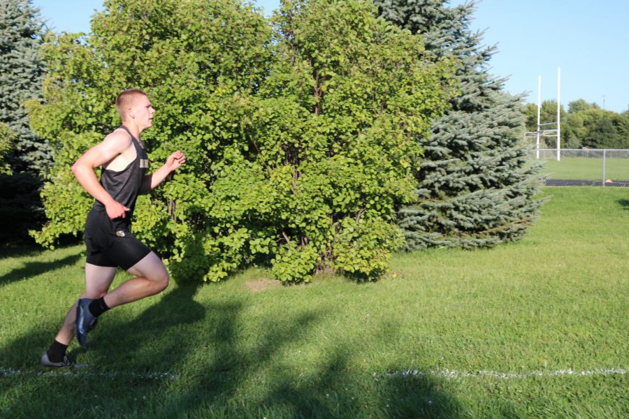 Junior Craig Alan Becker speeds by during the time trials at the beginning of the season. Becker finished fourth on Monday.