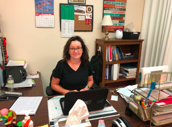 Kelli Evans, the high school nurse, sits are her desk in the nurses office. Evans has all sorts of information of vaping and its side effects.