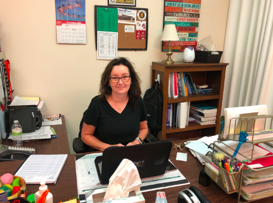 Kelli Evans, the high school nurse, sits are her desk in the nurse's office. Evans has all sorts of information of vaping and its side effects.