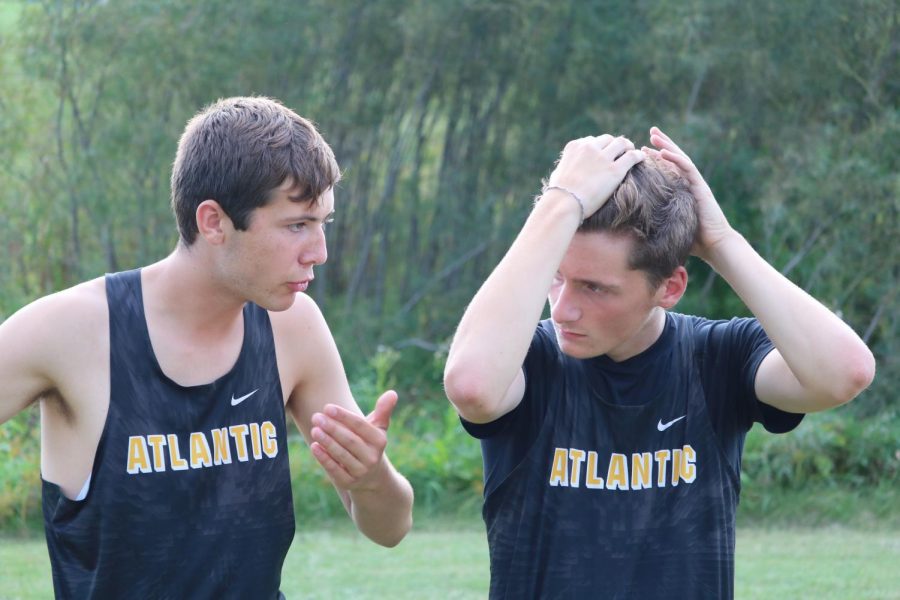 THE END OF AN ERA -- Seniors Clayton Jipsen and Zach McKay are deep in conversation. Both have been involved with cross country since their freshman year.
