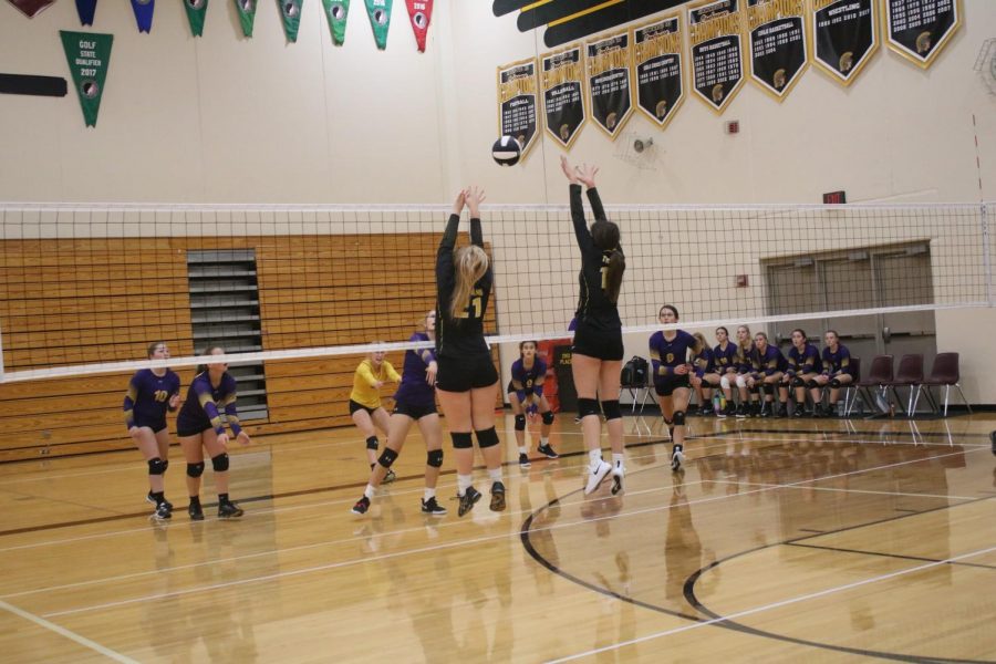 Senior Emma Templeton and freshman Aubrey Guyer come together at the net to put up a block. Templeton plays right-side hitter, while Guyer is a middle hitter.