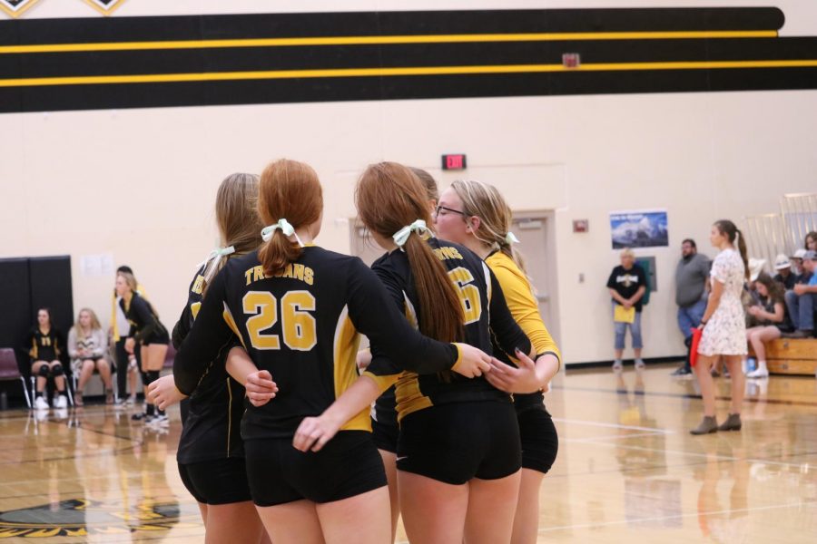 The freshmen volleyball team huddles after an exciting point. Smith plays on the varsity and freshmen teams.