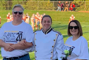 Senior Erin Barrick poses with her parents on Senior Night. She is the youngest child in her family.