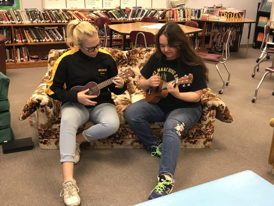 Juniors Beverly Dodson and Jasmyne Oasay-Waddell play some chords on the ukuleles in Allison Berryhill's classroom. 