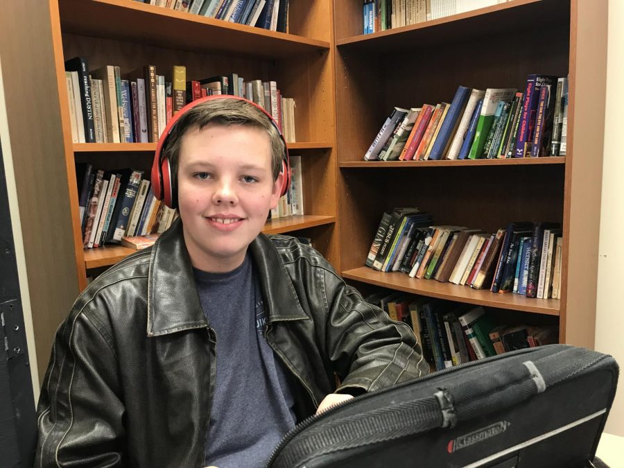 Sophomore Brycen Erickson tunes into his music during drama class. Ericksons headphones are bluetooth.