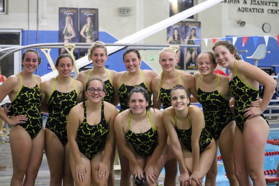 The girls swim team poses for a picture at the Nishna Valley YMCA. Many of the girls on the team swim in the offseason as part of the YMCA squad.