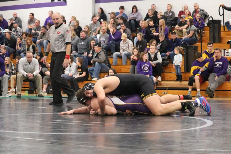 Senior Cale Roller lays on top of his opponent in one of the duals last year. Roller has been on the varsity squad since his freshman year.