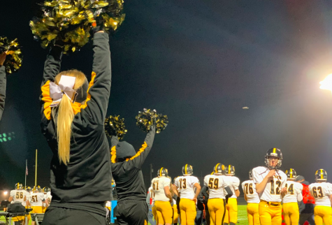 Junior Mia Trotter cheers on the Trojans at their last football game. Trotter has been on the cheer squad since her freshman year.