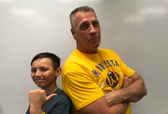 Freshman Clevi Johnson stands next to history teacher Terry Hinzmann. A member of the baby boomer generation, Hinzmann hears the okay boomer comments on the daily.