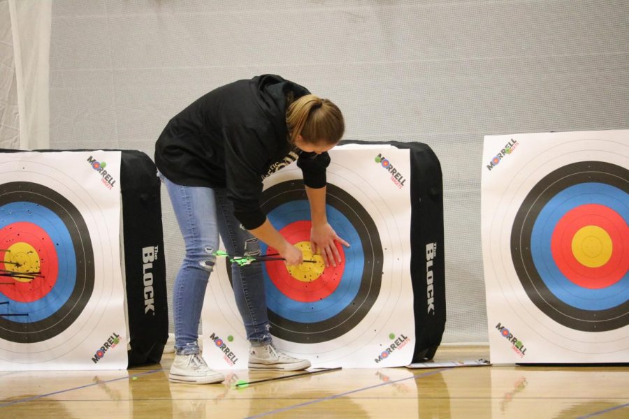 Freshman Halle Copeland collects her arrows during the bullseye event. Copeland finished first amongst the Trojan girls in the bullseye competition. 