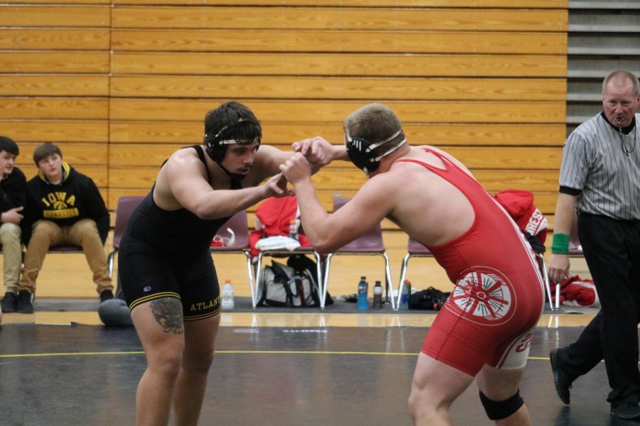 Senior Cale Roller faces off against his opponent from Audubon. Roller has wrestled as part of the varsity team since his freshman year. 
