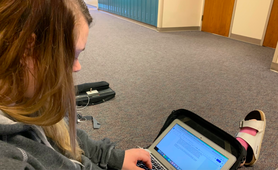 Editor Camryn Church finishes a news brief for the website. Church is a part of the third-period editing class that works in the hallway.