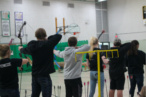 Archers prepare to shoot their arrows. The archery team is comprised of middle and high schoolers. 