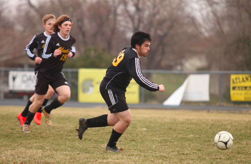 Junior Keagen Garcia races after the soccer ball last season. Garcia has been on the team all throughout high school.