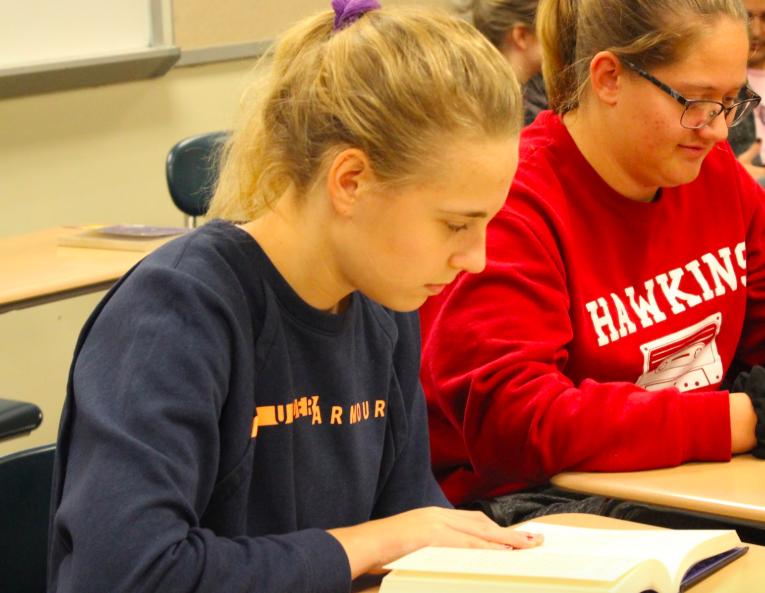 Seniors Hana Holtz and Belle Wickman read novels in Contemporary Literature. The goal for the class is to read seven books before the semester ends. The teacher, Emma Bireline, believes anyone can learn to be a reader.