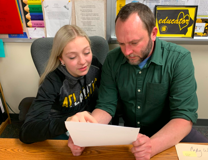 English teacher Randall Simpson helps sophomore Jaci Smith look over her resumé. All students had to build a resumé and cover letter to include in their portfolio for the mock interview.