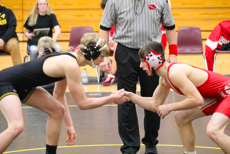 Sophomore Kadin Stutzman shakes hands with an opponent before a match. 