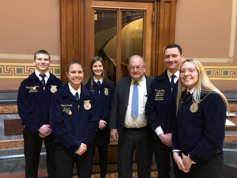 Juniors Craig Alan Becker, Taylor McCreedy, and Alyssa Derby, and seniors Tate Den Beste and Corri Pelzer stand with state senator Tom Shipley. The FFA members got the chance to chat with Shipley on Tuesday in Des Moines.