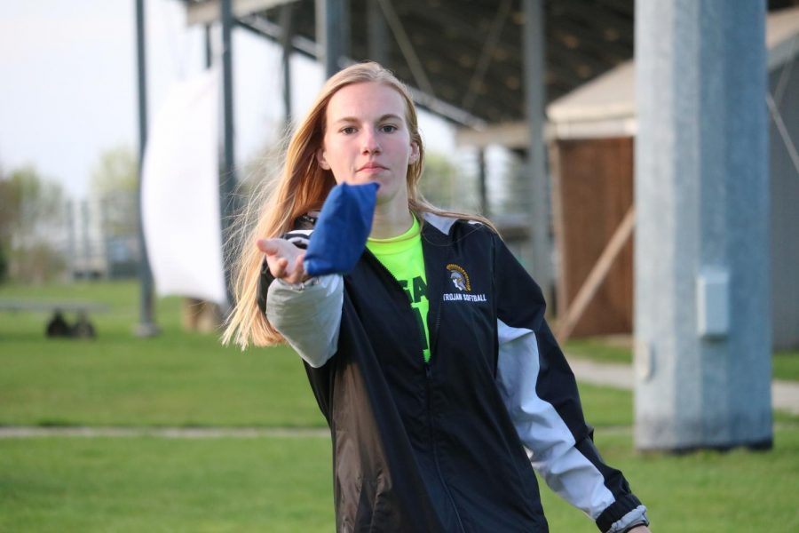 Junior Maddie Botos tosses a bean bag in a game of cornhole. All sorts of activities can be found at Game Night.