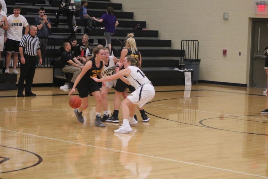 Senior Corri Pelzer sets a screen for senior Kenzie Waters. Both girls have played basketball all four years of high school.