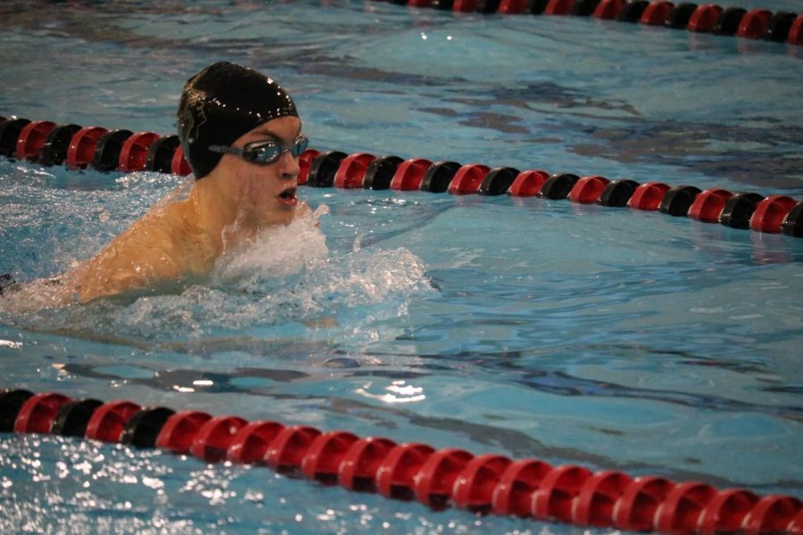 Sophomore Drew Engler cuts through the water during his event. Engler took fourth place in the 100-yard breaststroke.
