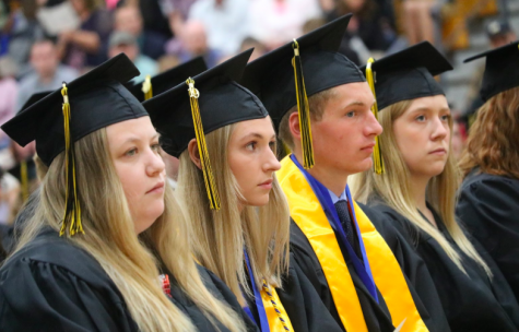 Hannah Anstey, Halsey Bailey, Nathan Behrends, and Alyssa Behrens sit together at graduation. Last year, the speaker for Commencement was history teacher Trace Petersen.