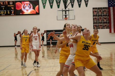 Senior Corri Pelzer boxes out her girl on a free throw shot. Pelzer averages 5.3 rebounds per game, leading her team.