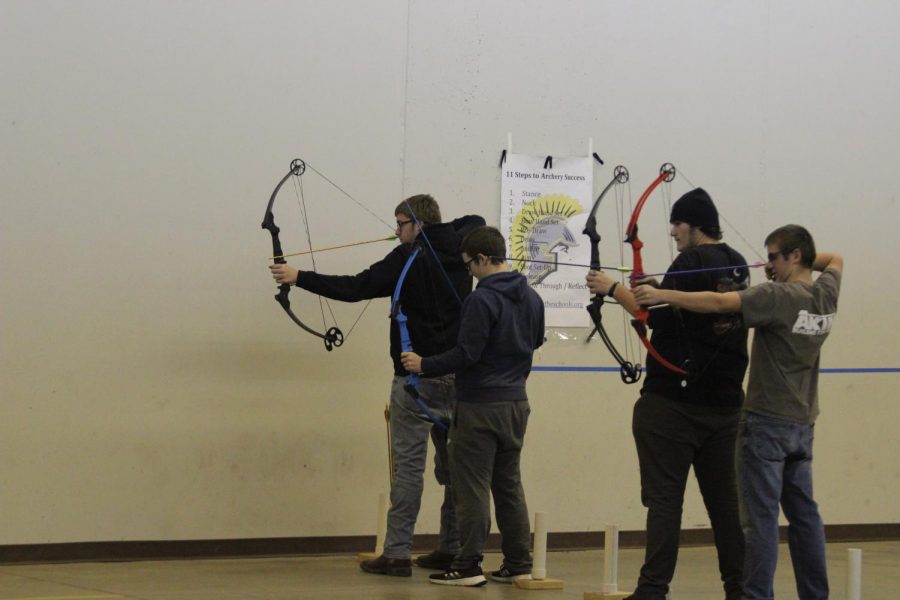 Twin brothers Derek and Dustin Dreager shoot with senior McCade Stillian and junior Zach Colton at archery practice. The Dreager boys have been involved with archery throughout high school.